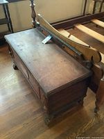 Top and side of cedar chest showing surface wear, lid, and attached headboard not included