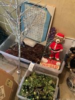 Overview showing tinsel tree, Pokémon chart, plush bear, Ice-Glo box, ornaments bin