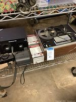 Shelf view showing Soundesign unit, Polaroid camera, sealed cassette packs, and Sony tape recorder