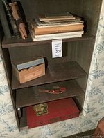 Bookshelf showing Erector case, books, knife and box