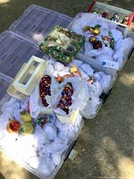 Wide view of storage bins holding wrapped vintage glass ornaments and garlands