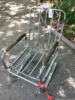 Full view of metal glider chair frame front angle