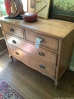 Front view of light wood 4-drawer dresser