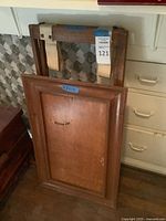 Tray and folded stand leaning against wall