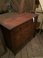 Front view showing full chest, four drawers, mixed knobs