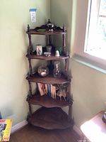 Full view of five-tier corner shelf with contents