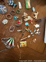 assorted jewelry pieces laid out on wooden surface