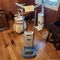 Upright Electrolux Floor Pro heavy-duty floor cleaner shown from front in room with wooden floor and furniture.