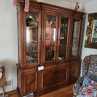 Full view of the Thomasville wooden china cabinet showing glass display sections, drawers, and lower cabinets