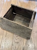 Open top view of the antique wooden box showing interior and front panel.
