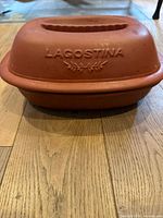 Side view of the closed roaster showing the Lagostina embossed brand on terracotta lid.