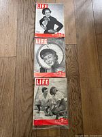 Three vintage LIFE magazines from 1948 with black-and-white covers showing portraits and candid outdoor scenes.