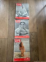 Three vintage LIFE magazine covers from 1948 showing a person sitting cross-legged in casual wear, a woman in a contemplative pose, and a woman in a swimsuit on grass.