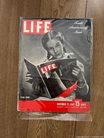 Front cover photo of Life magazine Tenth Anniversary Issue November 25, 1946 showing a girl reading a Life magazine, sealed in protective plastic.