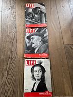 Three vintage LIFE magazine issues from 1947 displayed on wood floor, covers visible.