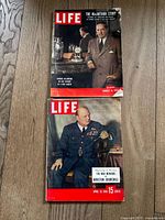 Photo of two LIFE magazines: August 15, 1955 issue on top, April 19, 1948 issue below on a wood floor.