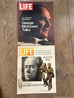 Photo shows two LIFE magazine covers. Upper magazine dated July 7, 1972 with George McGovern cover. Lower magazine dated June 23, 1971 with Alexander Solzhenitsyn and WWI battle scene on cover.