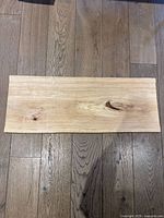 Top view of rectangular maple wood charcuterie board showing natural wood grain and knots.