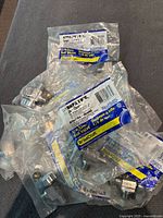 Plastic bags containing KTBRPX 19 C Angle Chrome 1/4 turn ball valves, new and individually packaged.