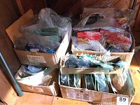 Boxed assortment of masks and mask accessories in various packaging and plastic bags.