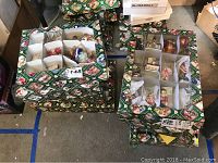 Multiple boxes containing Old World Christmas ornaments including nutcrackers, stars, patriotic elephants, soldiers, and more in original packaging.