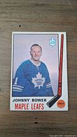 Front side of the 1969 Johnny Bower hockey card showing player image, team logo, and stats symbols.