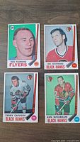 Front of 4 hockey cards from 1969 O-Pee-Chee (OPC) set showing players Reg Fleming, Eric Nesterenko, Terry Caffery, Ken Wharram.