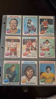Front side of 9 hockey cards from 1975 OPC set showing players Red Berenson, Gerry Hart, Ed Van Impe, Ed Giacomin, Germain Gagnon, Gilles Marotte, Andre Boudrias, Colin Campbell, Mike Christie.