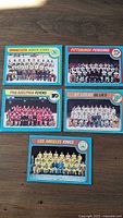 Front side of 5 OPC 1979 team hockey cards showing team photos and logos for Minnesota North Stars, Pittsburgh Penguins, Philadelphia Flyers, St. Louis Blues, and Los Angeles Kings. Two cards have visible markings on front.