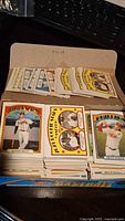 Open box showing a large quantity of loose 2022 Heritage Baseball Cards including cards featuring Atlanta Braves, Phillies, and other players.