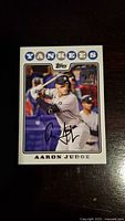 Front of the Aaron Judge 2021 Topps insert baseball card showing player batting and facsimile autograph.