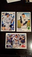 Three Aaron Judge baseball cards showing front side: two cards showing Aaron Judge in New York Yankees uniform, one card showing multiple players from American League batting leaders.