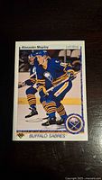 Front of Alexander Mogilny rookie card showing player in Buffalo Sabres uniform.