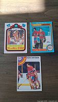 Three front images of Ken Dryden hockey cards showing the player in Montreal Canadiens goalie uniform and All Star designations.