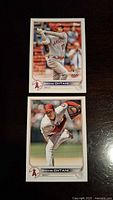 Front of two Shohei Ohtani baseball cards, showing batting and pitching action shots, the player in Angels uniform.