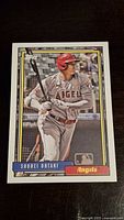 Front side of the 2021 Topps Shohei Ohtani insert baseball card showing photo of Ohtani in batting stance and team details.