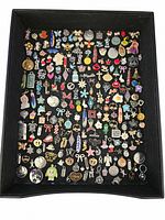 Photo of assorted colorful charms on black background, showing entire lot