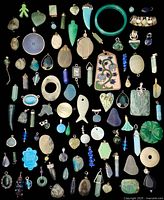 Overview of assorted charms and pendants in various shapes and materials on black background.
