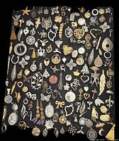 Full layout of charms and pendants showing variety of shapes, colors, materials, and styles.