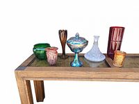 Group photo showing all vintage glass items, vases and carnival glass pieces on a wooden table.