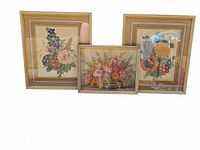 Three vintage floral pictures in gold-toned plastic frames; two larger vertical and one smaller horizontal.