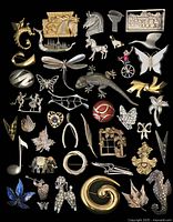 Full view of 44 vintage pins and brooches arranged on black surface showing various shapes, animals, and abstract designs.