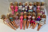 Front view of 17 vintage Barbie dolls arranged in two rows showing various outfits, hairstyles, and accessories