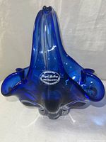 Front and top view of a cobalt blue art glass vase showing its deep blue color, ruffled edges, and original Royal Gallery label on the base.