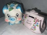 Photo showing front view of piggy bank and 'Pin Money' purse bank side by side, highlighting colors and floral detail.