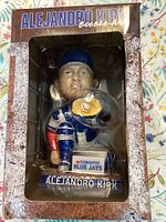 Front view of Alejandro Kirk bobblehead in original packaging box showing player name and team.