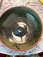 Top-down photo showing glossy green and blue interior glaze with speckled texture.