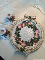 Platter and two candlesticks set on fabric backdrop, showing overall appearance and design.