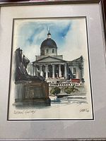 Full view of framed watercolour artwork showing the National Gallery in London with a lion statue in the foreground and a cloudy blue sky background.