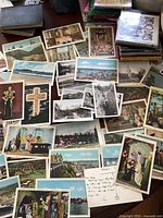 Photo showing a wide range of vintage Canadian postcards laid out on a table, including scenic views and historical sites.